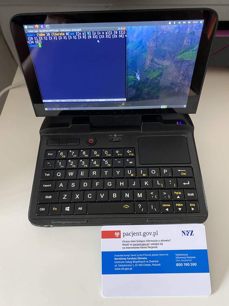 The GPD Micro PC running Emacs on Ubuntu MATE and a credit-size card for scale